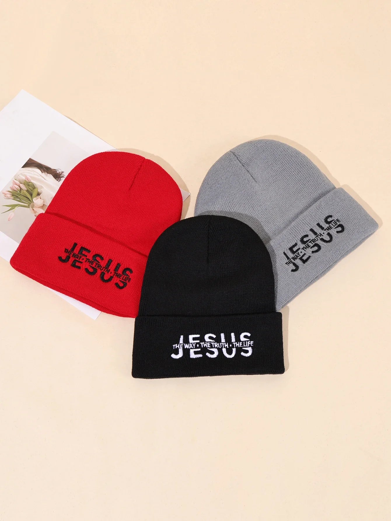 Three knitted warm beanies in red black and gray with jesus embroidered on the brim for autumn winter use