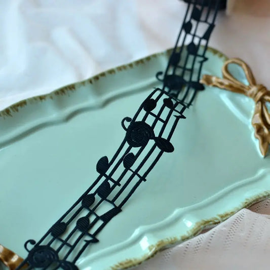 Black handmade cotton ribbon lace with music notes and clefs on light green tray for christmas decoration diy sewing fabric 3cm