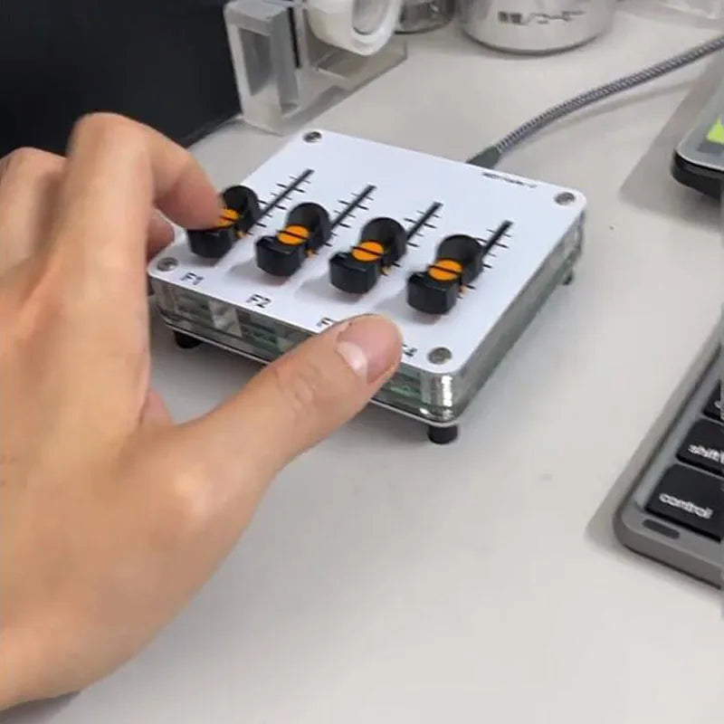 White rectangular audio mixer with four black knobs featuring orange centers labeled f1 to f4 in metallic frame midi push rod 42mm fader custom music host software controller