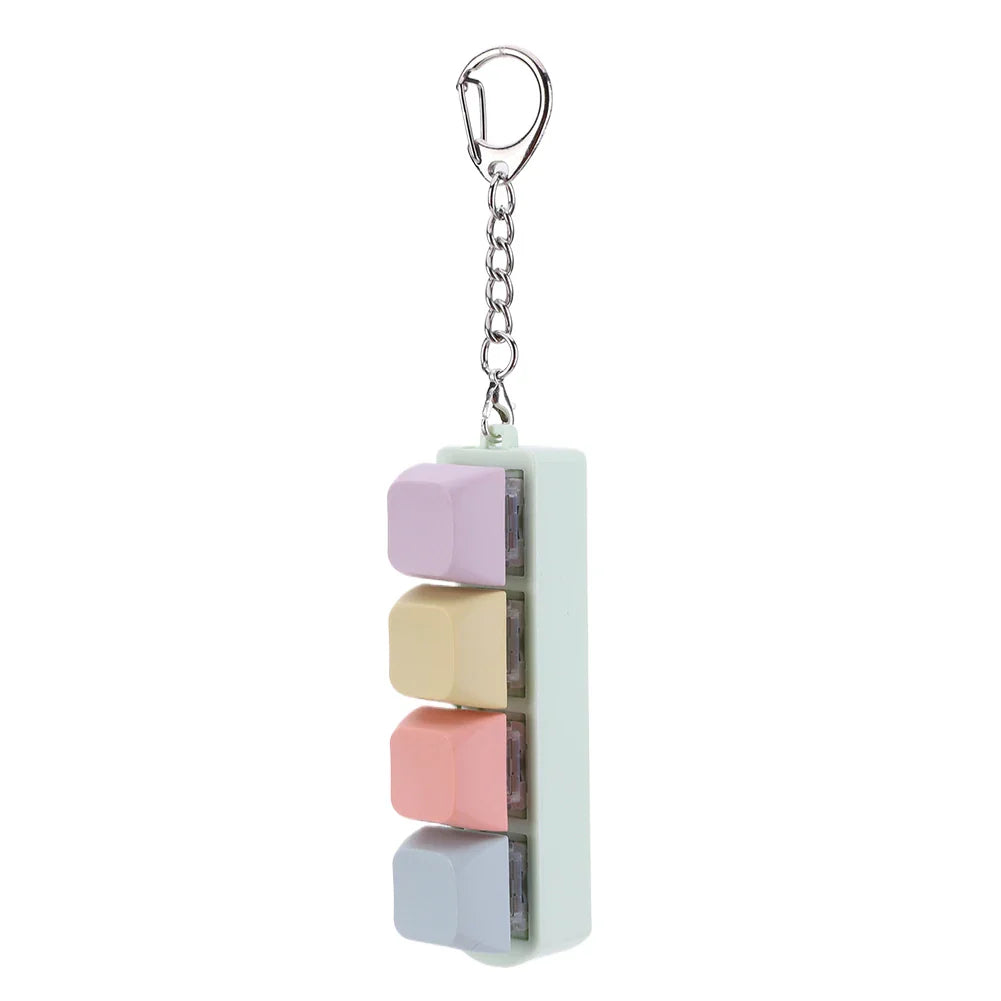 Pastel-colored keycap fidget keychain with four translucent cube segments for use as a keyboard clicker toy and stress relief