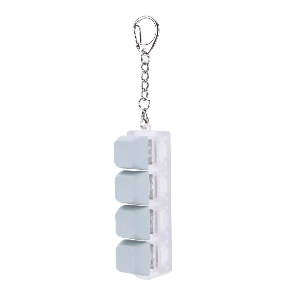 Transparent plastic keycap fidget keychain with four light blue square segments for keyboard clicker toy and stress relief
