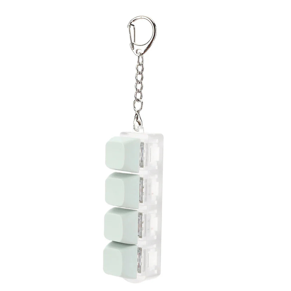 A translucent white keycap fidget keychain with four mint green cube keys arranged vertically as a keyboard clicker toy