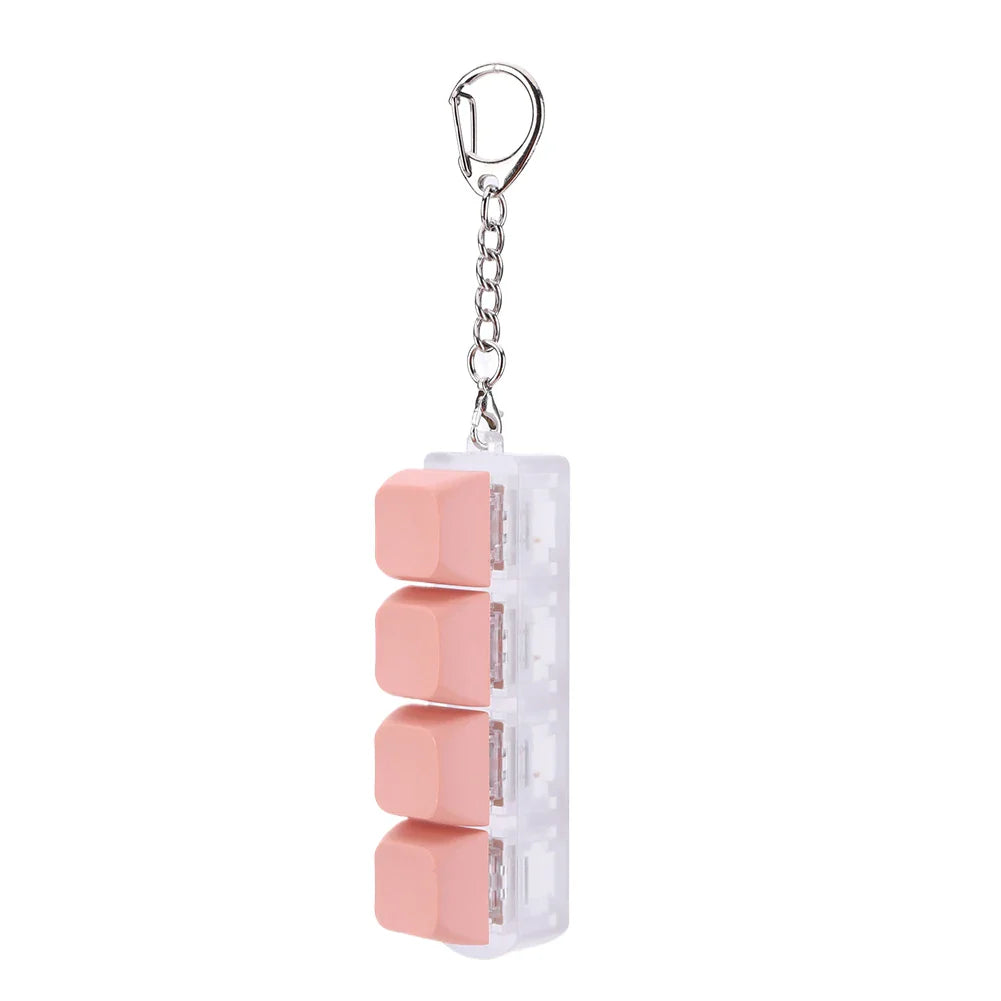 Pink silicone keycap fidget keychain with four stacked pill compartments and silver chain for keyboard clicker toy use