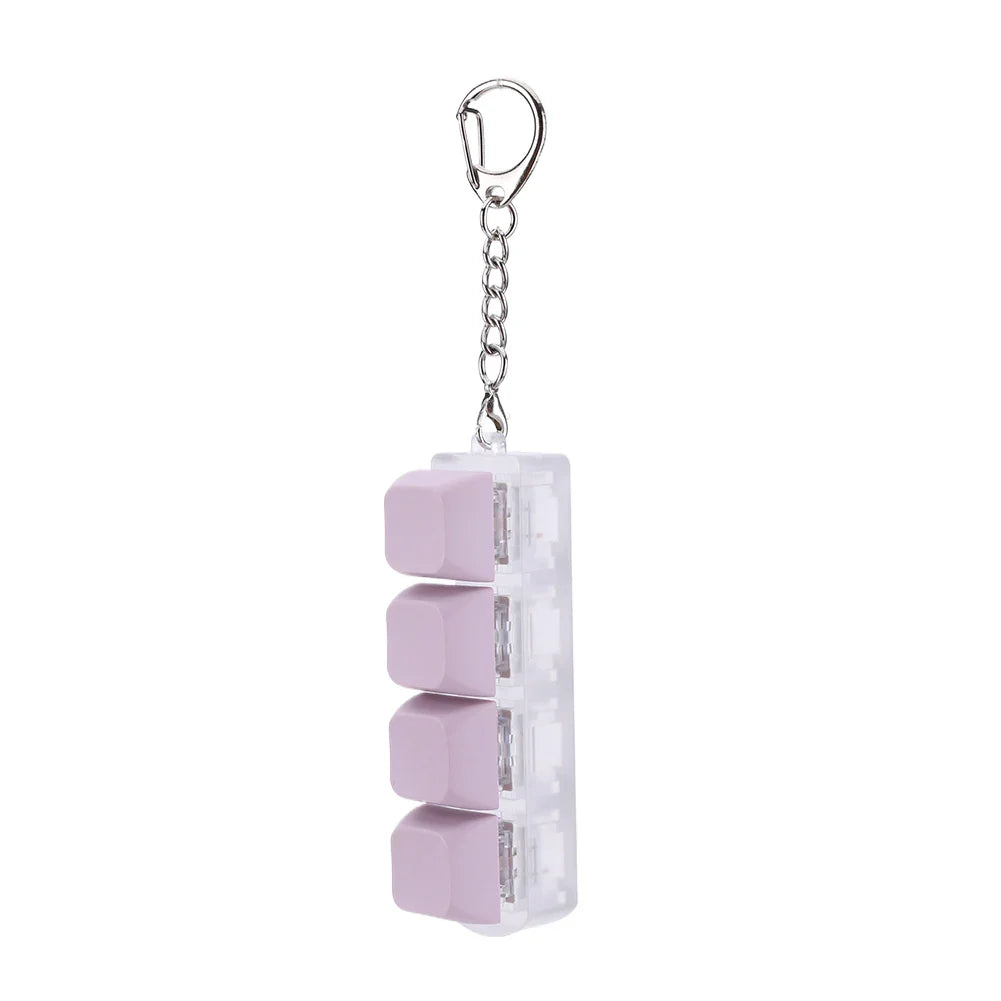 A translucent white keychain with four lavender keycaps serves as a keyboard key toy and keycap fidget keychain
