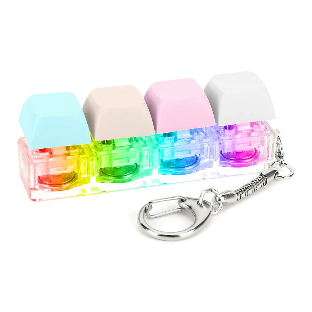 Rainbow-colored keyboard key toy with four keycap fidget keychain buttons in clear plastic case with metal attachment