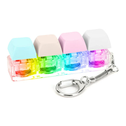 Rainbow-colored keyboard key toy with four keycap fidget keychain buttons in clear plastic case with metal attachment