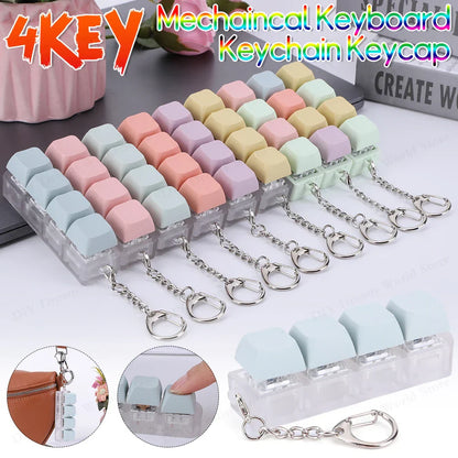 Pastel-colored mechanical keyboard keycap fidget keychains in clear tray with silver chains for keyboard clicker toy use