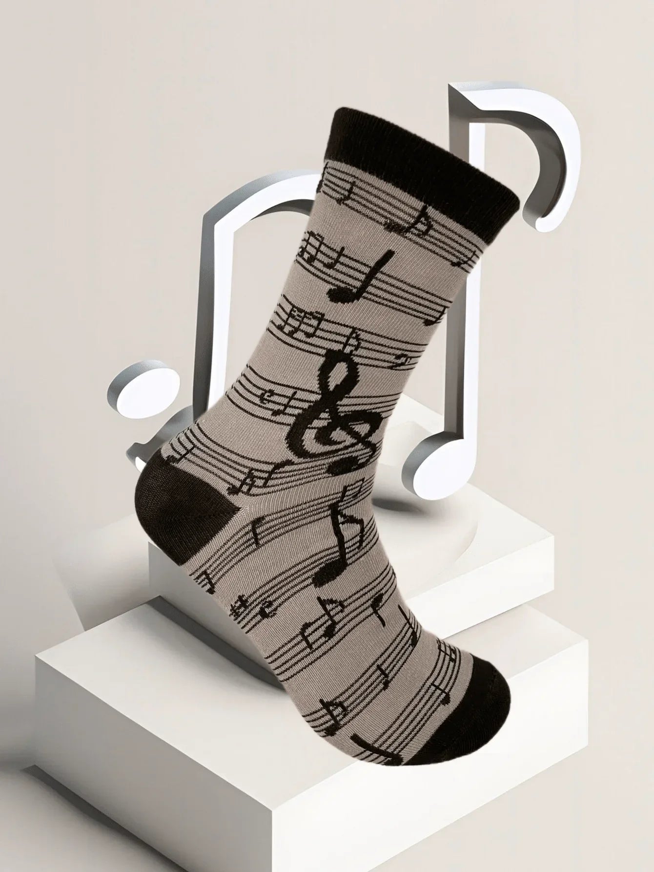 A black and gray men’s fashion music symbol sock featuring treble clefs eighth notes and staff lines pattern design