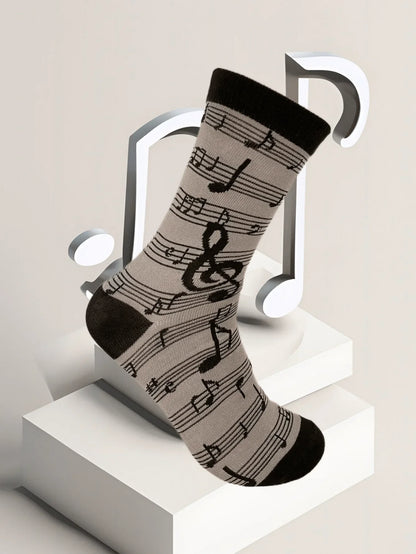 A black and gray men’s fashion music symbol sock featuring treble clefs eighth notes and staff lines pattern design