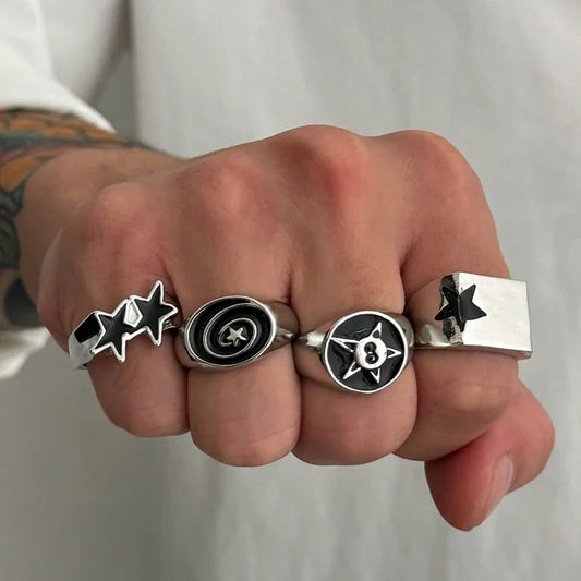 A set of 4 pcs punk black silver color finger ring y2k featuring black star rings and geometric enamel designs
