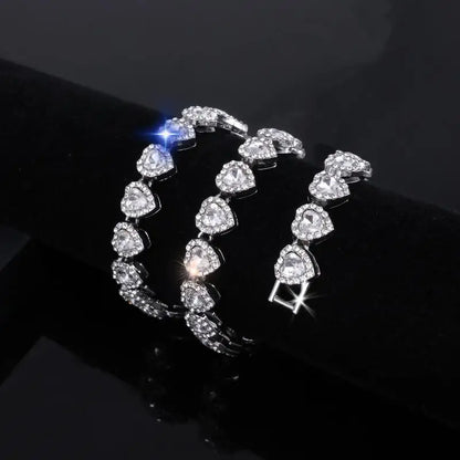 A sparkling silver tennis chain bracelet featuring shiny heart rhinestone crystals for rock party jewelry fashion