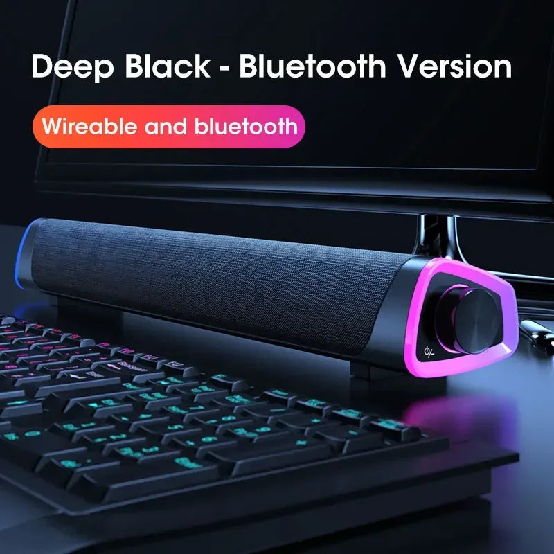 Deep black computer speaker bar with textured fabric grille and purple accent lighting featuring stereo sound subwoofer bluetooth