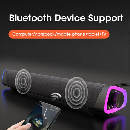 Black fabric-wrapped computer speaker bar stereo sound subwoofer with purple led lighting around volume knob for laptops