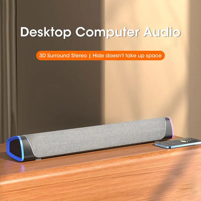 Gray fabric-covered computer speaker bar with blue and black accents stereo sound for macbook and laptop use