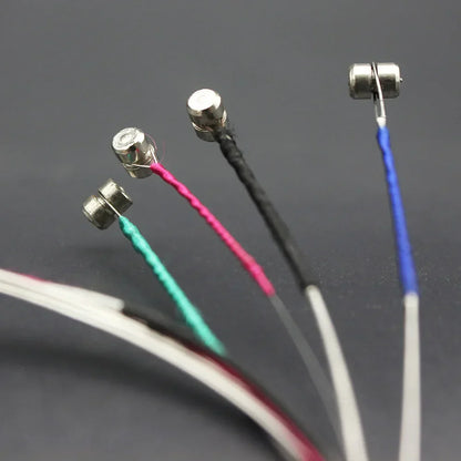 Silver-colored magnetic sensor probes with pink black blue and green insulated wires for violin strings steel core nickel use