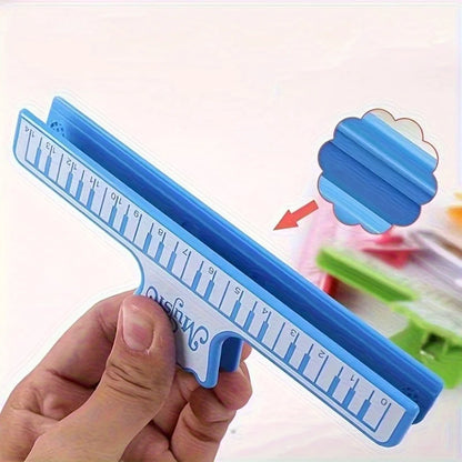 Blue plastic window squeegee with handle and measurement markings for cleaning glass surfaces by ultimate music book stands