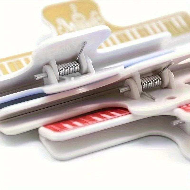 White plastic 4pcs music book clips with red and yellow metal springs for secure holding on sheet music stands