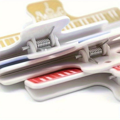 White plastic 4pcs music book clips with red and yellow metal springs for secure holding on sheet music stands