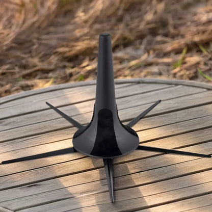 Black plastic trombone slide rest with four extended legs for stable support in foldable trumpet stand and black bracket