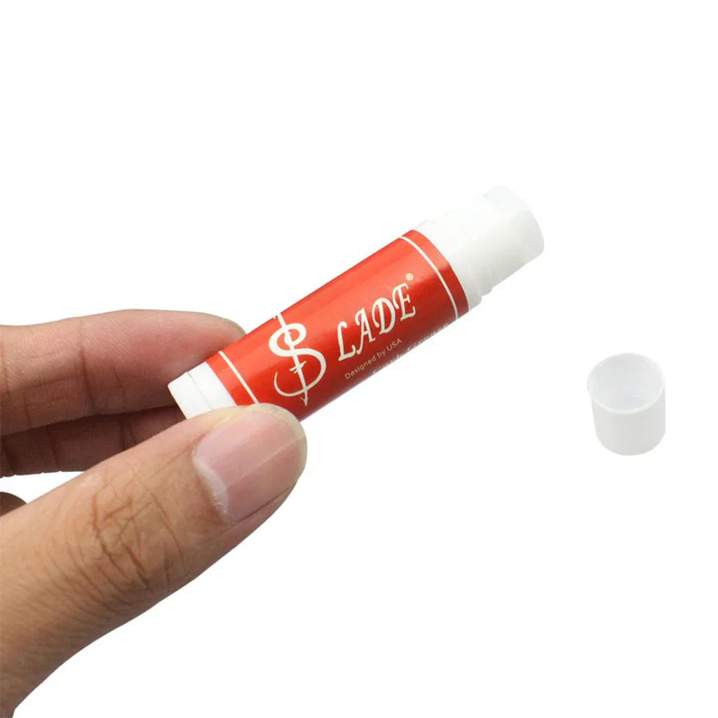 Red and white branded lip balm tube with dollar sign logo for high quality tubes cork grease use on instruments clarinet saxophone