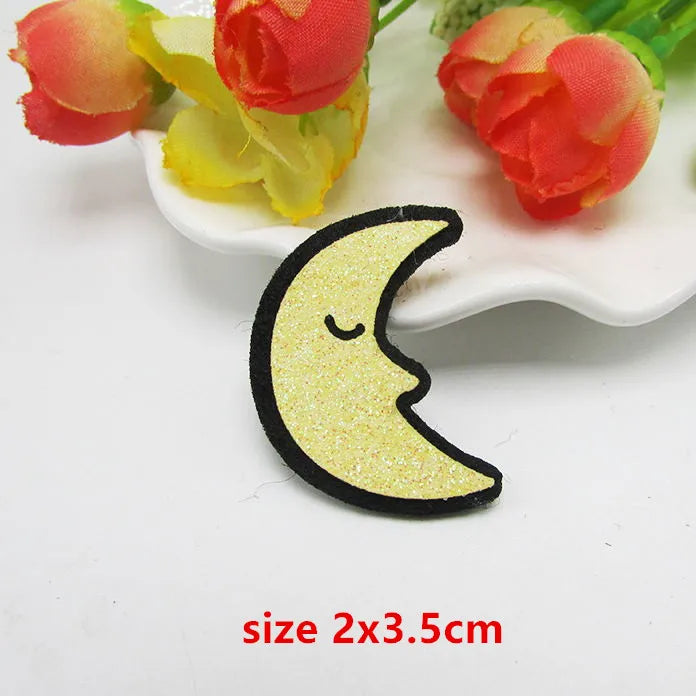 A glittery yellow crescent moon sparkle patch padded with black embroidered outline for applique decoration diy