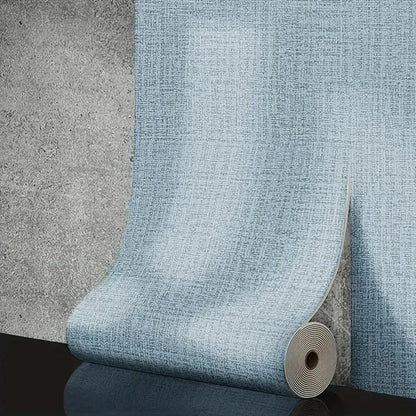 A light blue 50cm self-adhesive foam wall panel with a woven pvc texture partially unrolled on a gray wall for living room decor