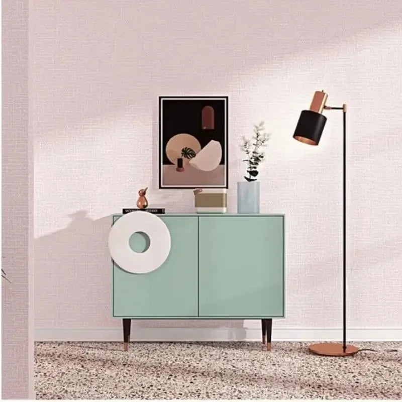 Mint green mid-century modern sideboard with white circular accent and tapered legs in living room decor setting