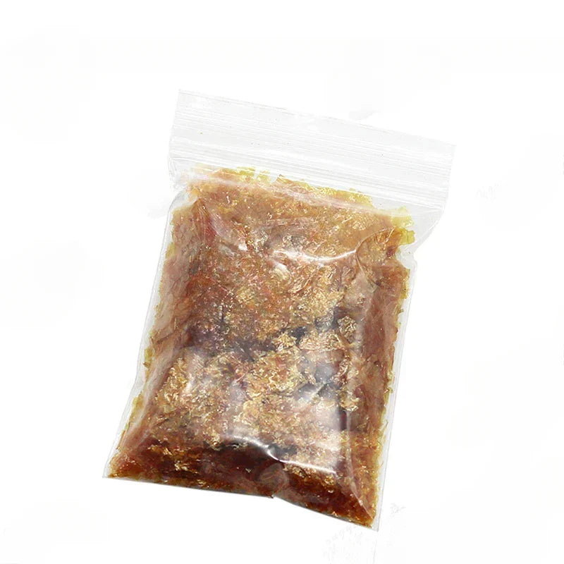 A clear resealable plastic bag containing 50g golden shellac varnish granules for primer handmade guitar material