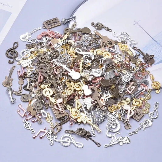 A collection of vintage random diy bulk violin guitar musical note charms in metallic colors for jewelry making