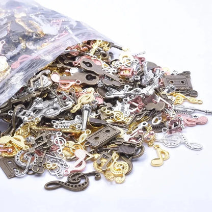 A collection of vintage random diy musical note charms in gold silver and bronze featuring bulk violin guitar designs