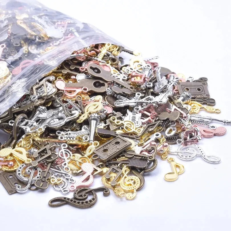 A collection of vintage random diy bulk violin guitar musical note charms in gold silver and bronze metallic finishes