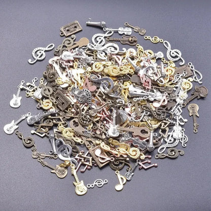 A collection of vintage random diy bulk violin guitar musical note charms in metallic colors for diy jewelry making