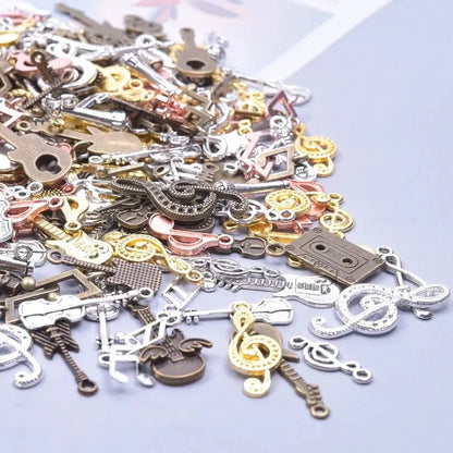 A collection of vintage random diy music-themed charms in silver gold and bronze featuring bulk violin guitar and musical note charms