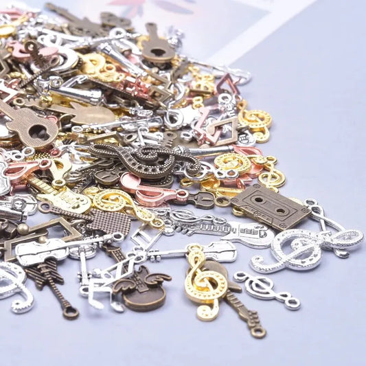 A collection of vintage random diy bulk violin guitar musical note charms in silver gold and bronze metal finishes