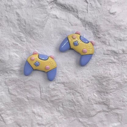 Pastel yellow and blue resin game controller stud earrings with pink accents from 5pcs cartoon resin phone resin cabochon set