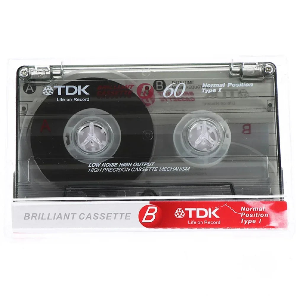 Clear plastic tdk high qulity standard cassette blank tape with black spools and red labeling for magnetic audio tape recording