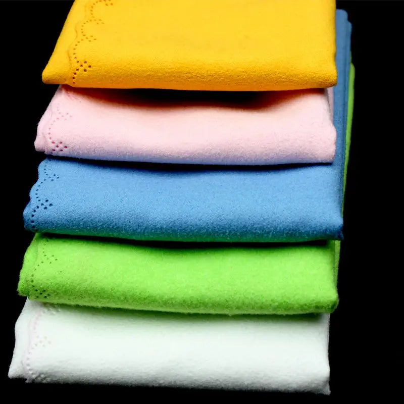Stack of six folded vibrant microfiber cleaning cloths in yellow pink blue green and white for musical instrument guitar violin piano clarinet