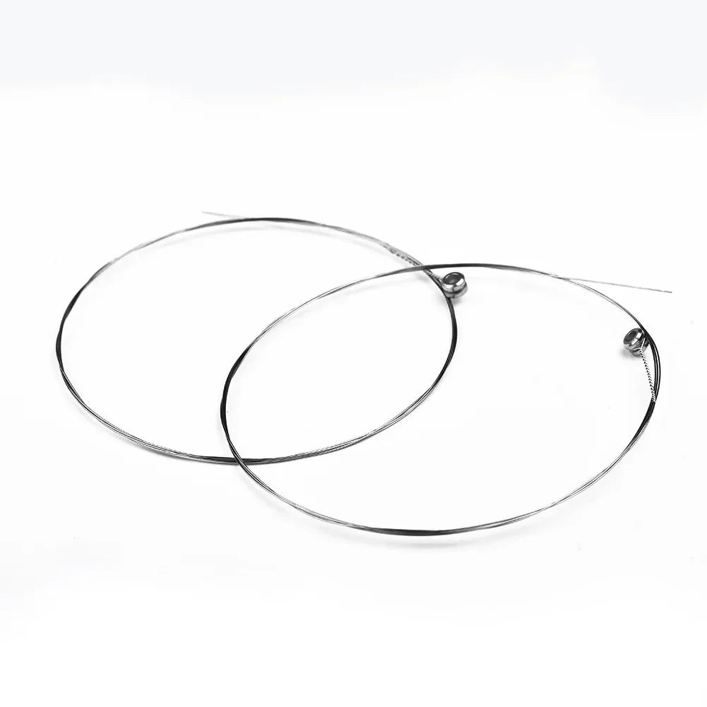 Two black circular metal wire hoops with small spherical ends for single guitar strings acoustic replacement musical instrument