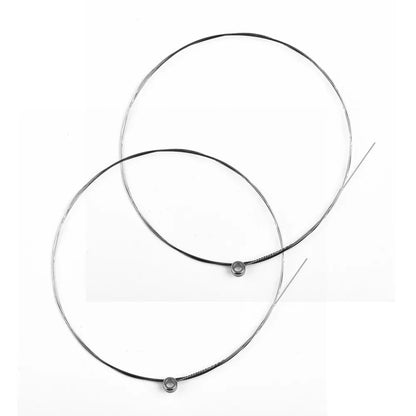 Two black and silver single guitar strings acoustic with metallic ball ends for replacement musical instrument use