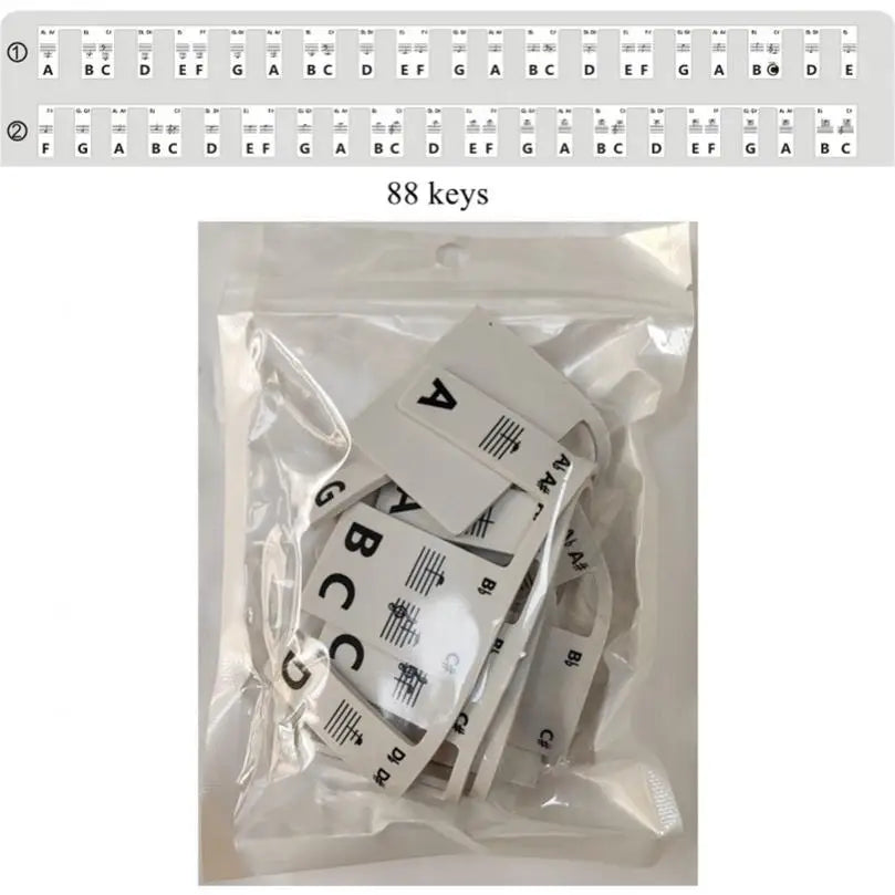 White rectangular silicone strips with black keyboard note labels and musical staff symbols in clear plastic bag