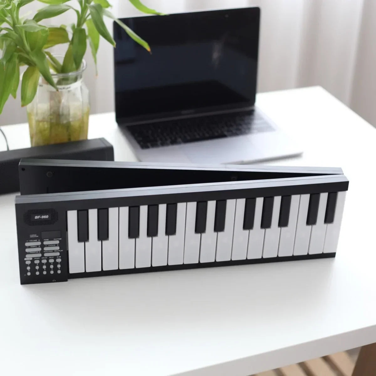 Black and white 49-key battery electronic keyboard with control buttons on left side for portable electronic keyboard musical use