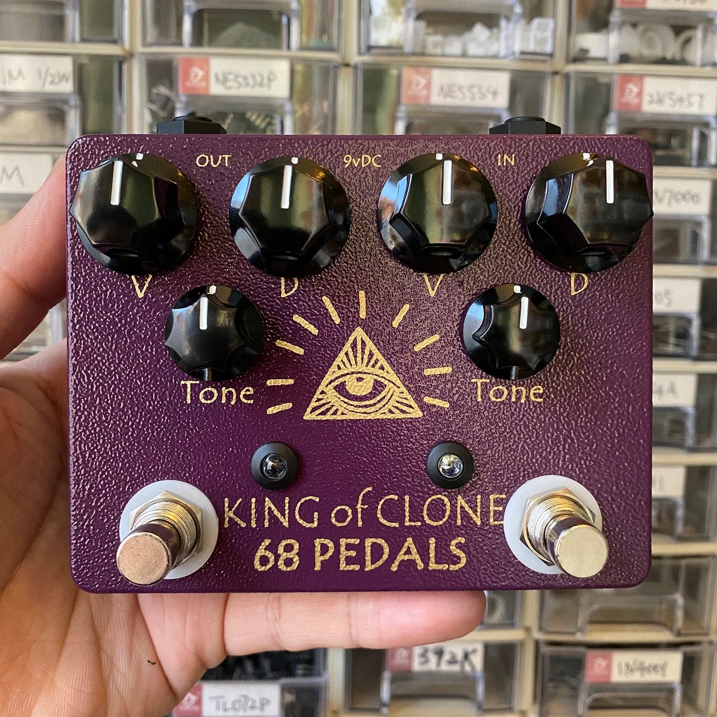 Purple textured 68pedals king of tone high gain effects pedal with black hex knobs gold foil lettering and eye symbol