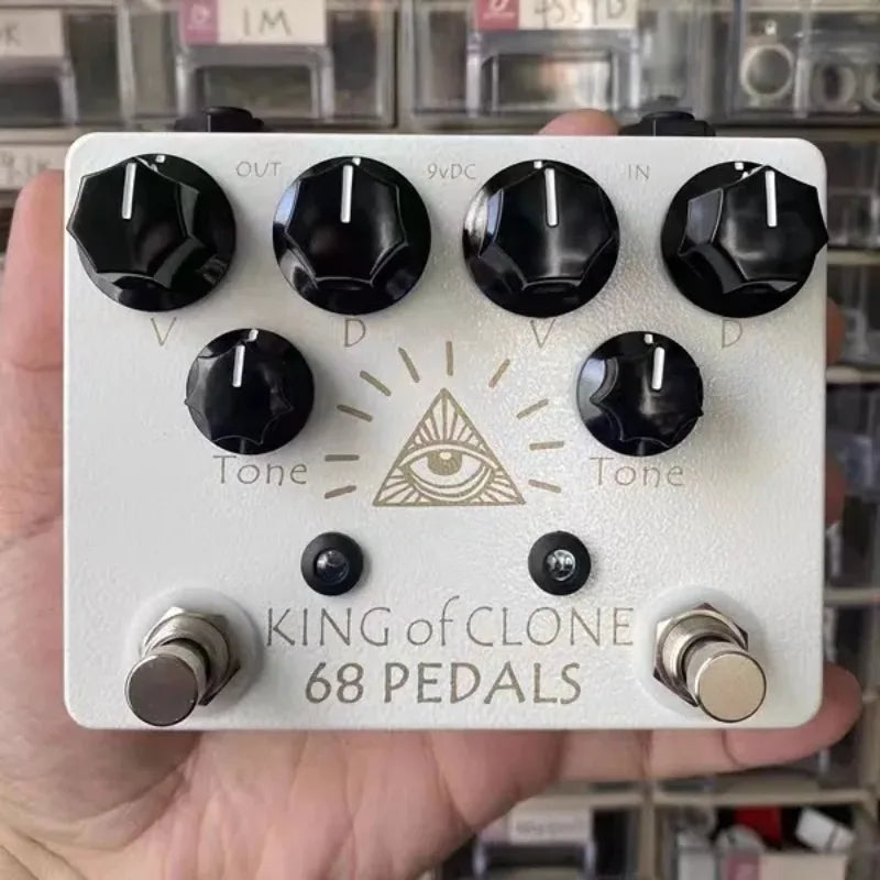 White rectangular high gain effects pedal with black knobs and gold eye symbol by 68pedals king of clone