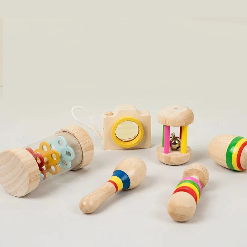 Wooden toy camera with yellow lens and beige body included in 6pcs educational baby rattle musical instrument xylophone set
