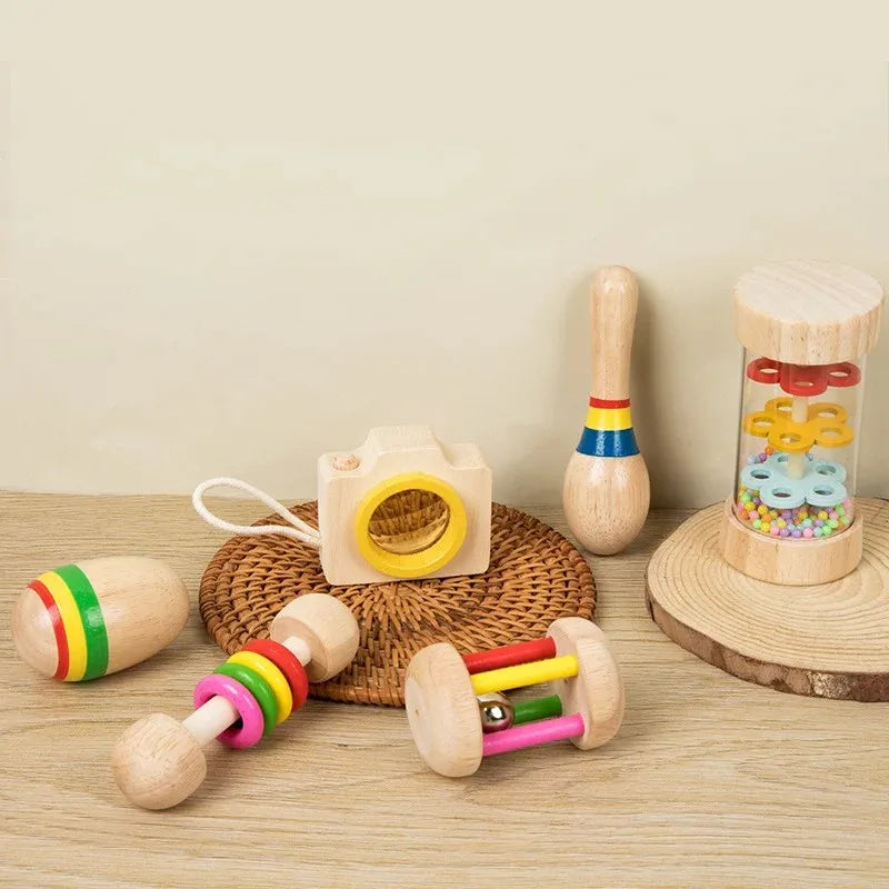 Wooden educational baby rattle with yellow lens and white body as part of a musical instrument xylophone set for sensory play