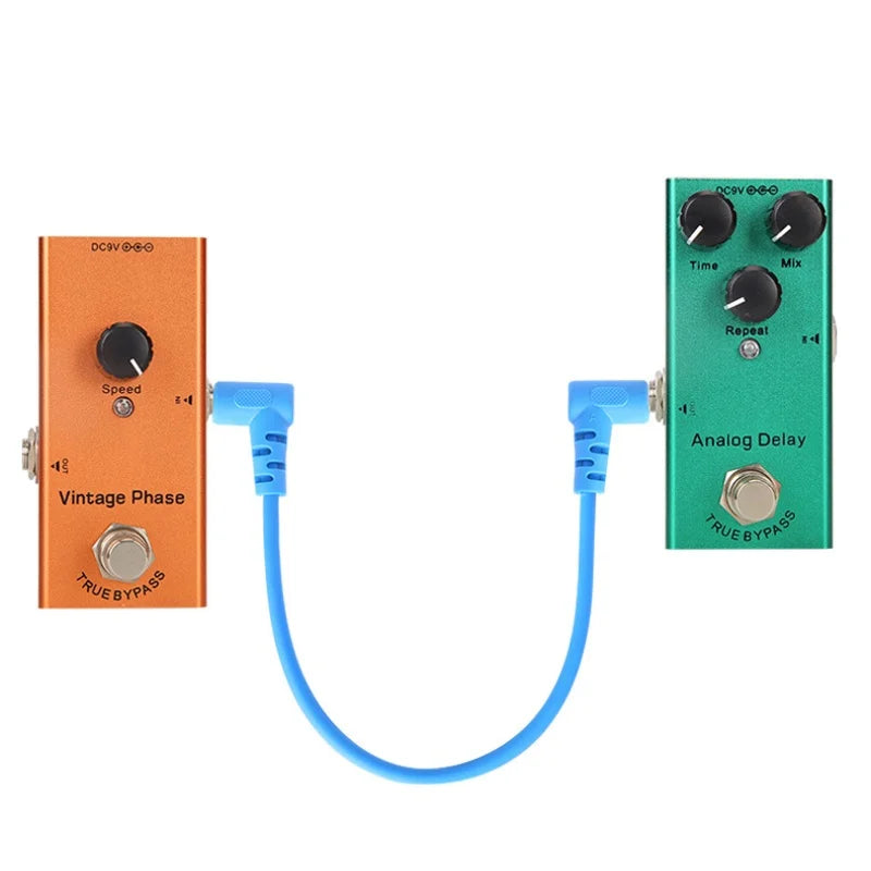 Orange and green guitar effect pedals connected by a blue low noise shielded electric guitar effect patch cable