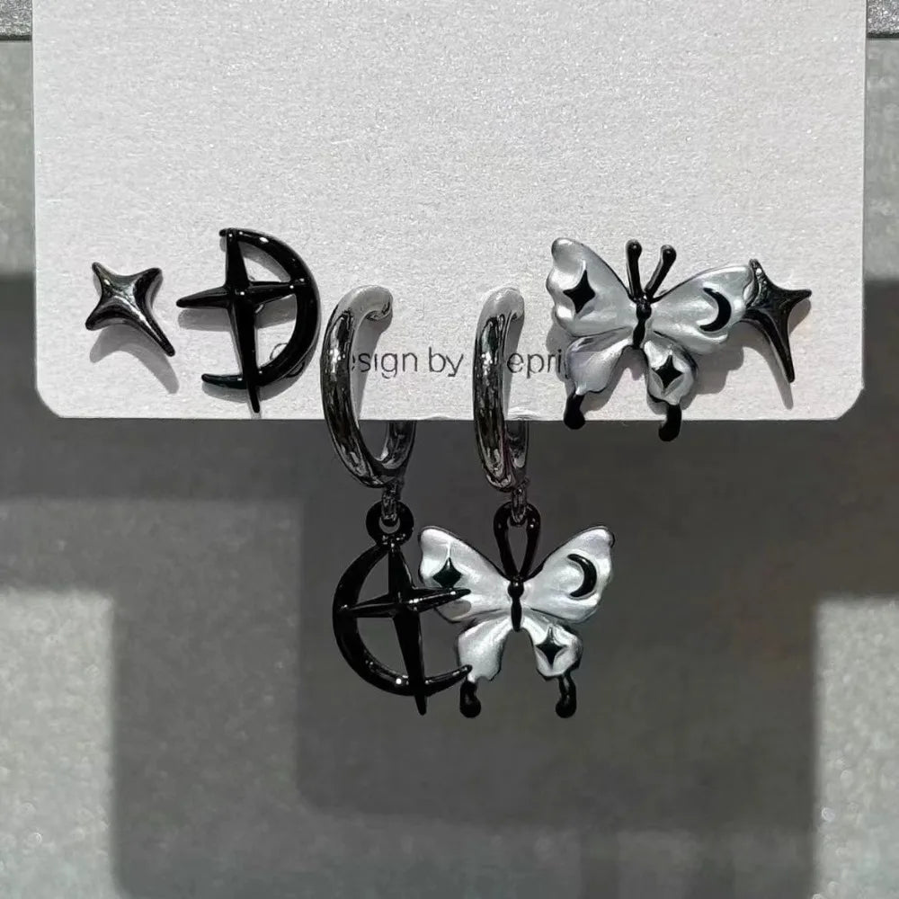 Black and silver celestial-themed hoop earrings with dangling butterfly charms featuring moon star accents rock y2k jewelry