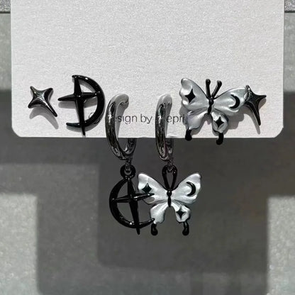 Black and silver celestial-themed hoop earrings with dangling butterfly charms featuring moon star accents rock y2k jewelry