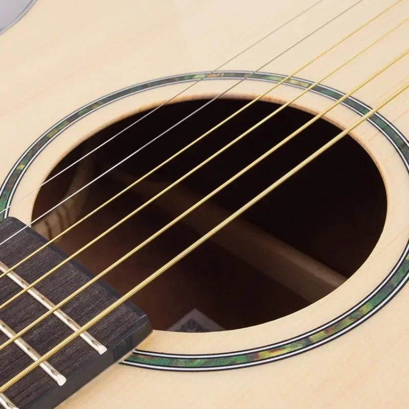 Acoustic guitar with light wooden body and dark fretboard featuring 6pcs set universal guitar string brass hexagonal steel core strings