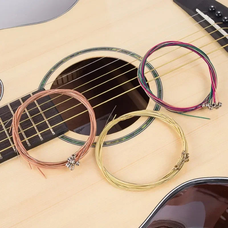 Sixpcs set universal acoustic guitar string brass with hexagonal steel core in copper gold and purple hues on guitar body